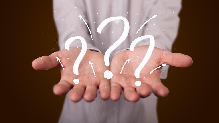 Male hands with question marks | dentist in fayetteville